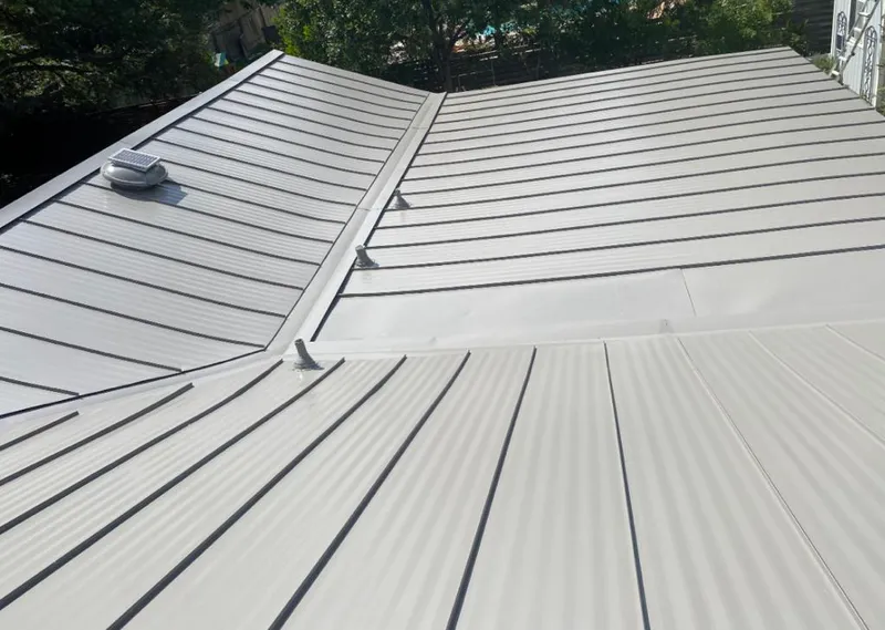 Solar attic fan installed on a metal roof for Roof Ventilation in Florida Gulf Coast University