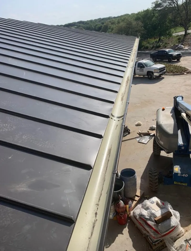 Standing seam panel and gutter detail on a metal roofing jobsite in Florida Gulf Coast University